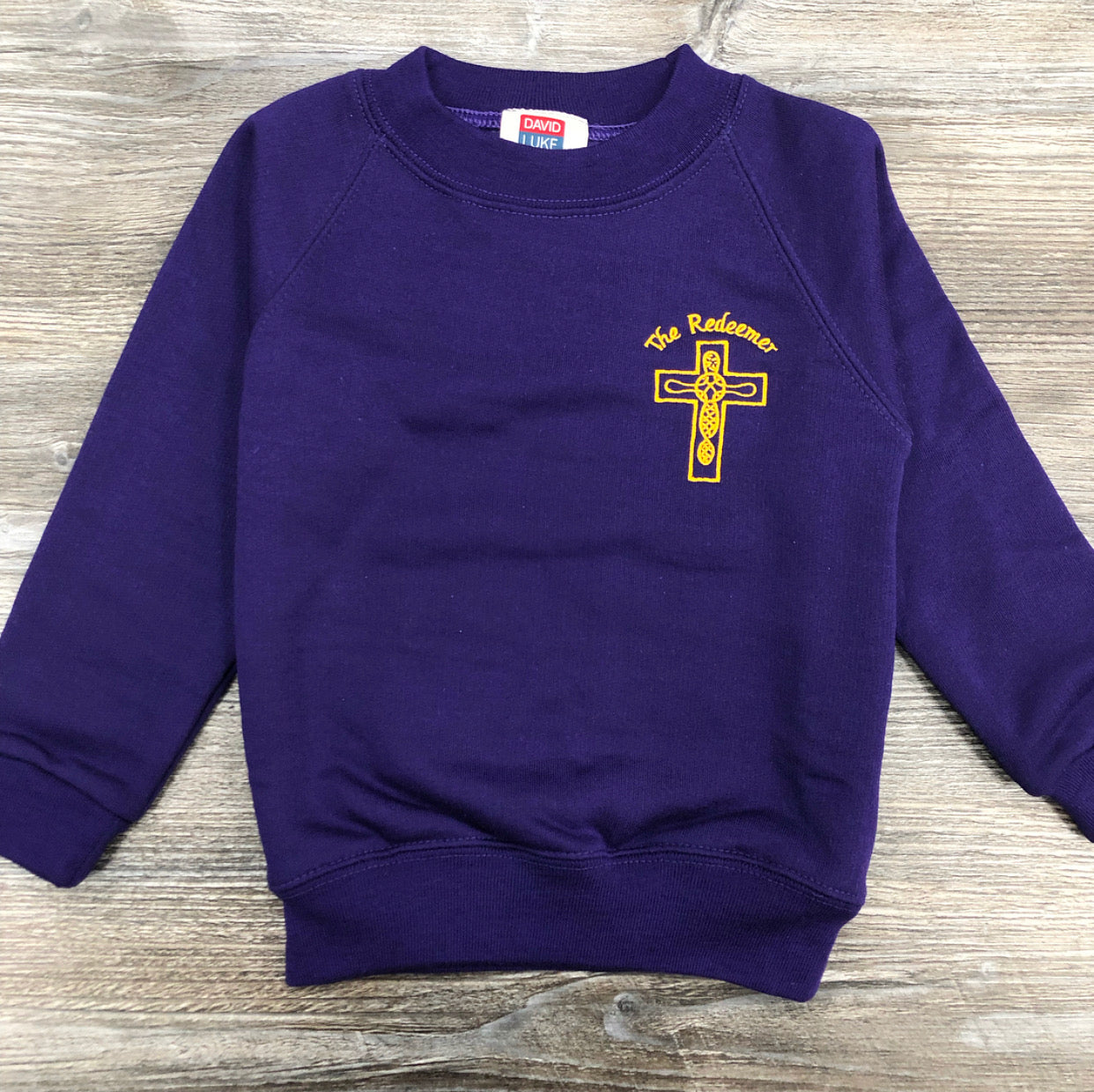 The Redeemer purple crew neck sweatshirt.